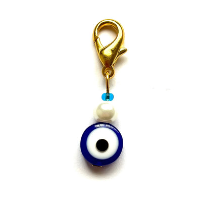 Navy Evil Eye with Bead good luck charm with pearl and gold clasp on a white background