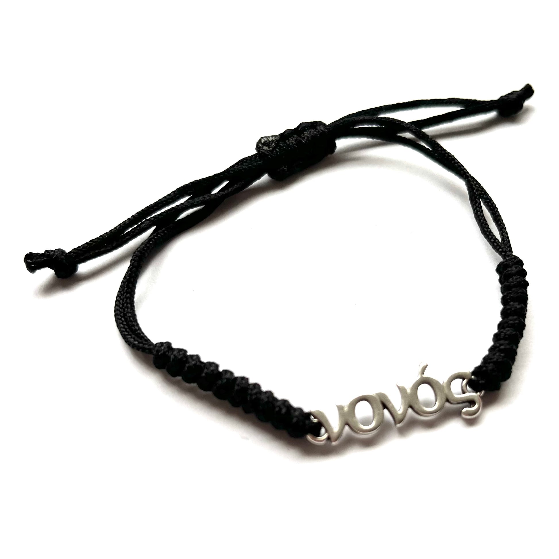 Black braided bracelet with a silver 'νονός' charm on a white background